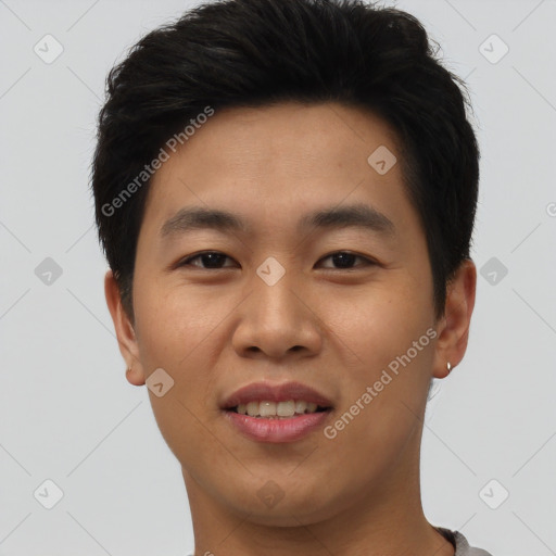 Joyful asian young-adult male with short  brown hair and brown eyes