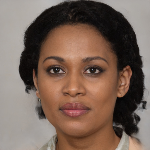 Joyful black young-adult female with medium  black hair and brown eyes