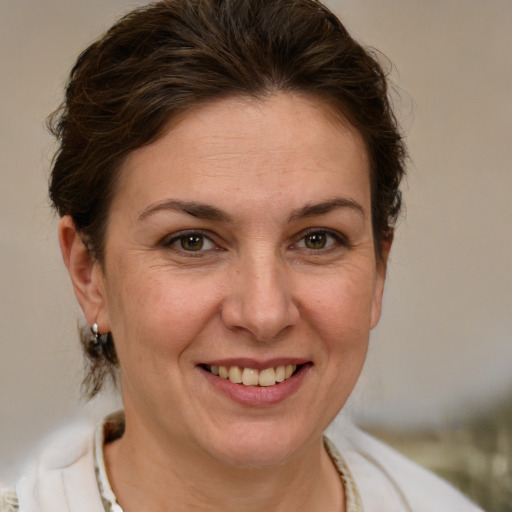 Joyful white adult female with medium  brown hair and brown eyes