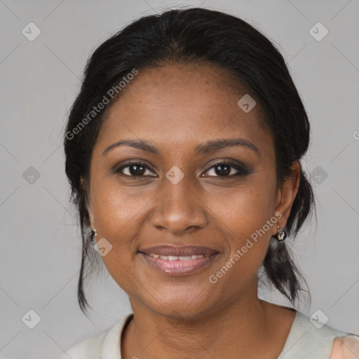 Joyful black adult female with medium  brown hair and brown eyes