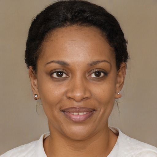 Joyful black young-adult female with short  brown hair and brown eyes