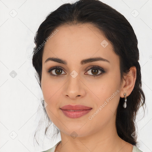 Joyful latino young-adult female with medium  brown hair and brown eyes