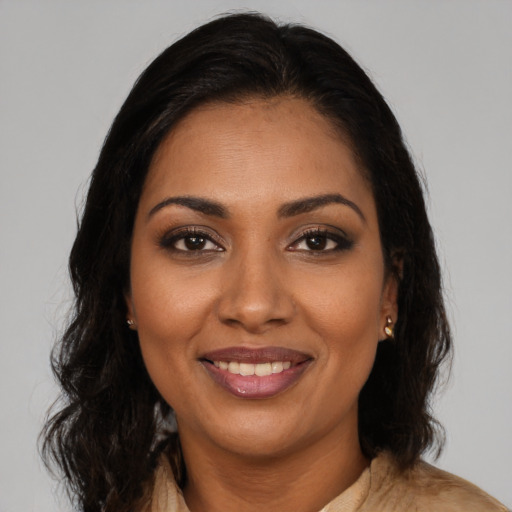 Joyful black young-adult female with long  brown hair and brown eyes