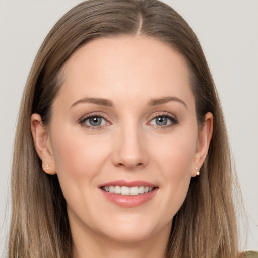 Joyful white young-adult female with long  brown hair and grey eyes