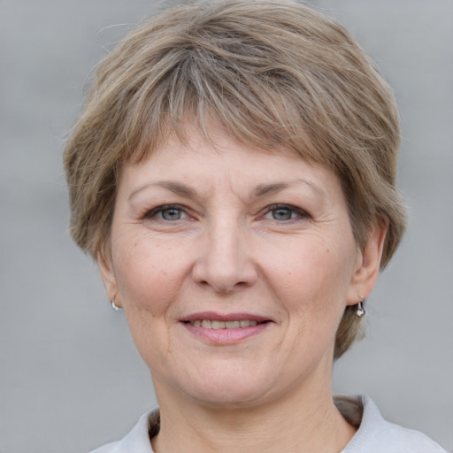 Joyful white adult female with short  brown hair and grey eyes