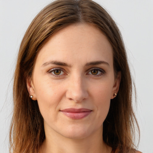 Joyful white young-adult female with long  brown hair and brown eyes