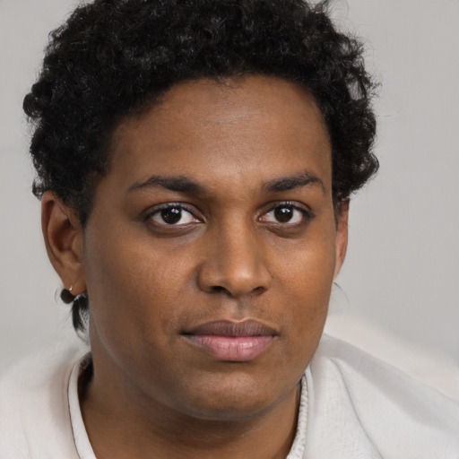 Joyful black young-adult female with short  brown hair and brown eyes