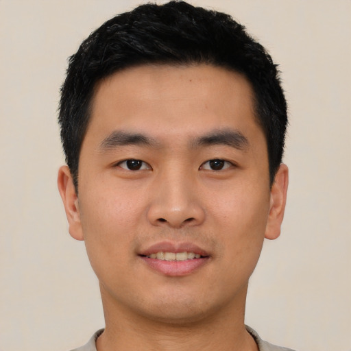 Joyful asian young-adult male with short  black hair and brown eyes