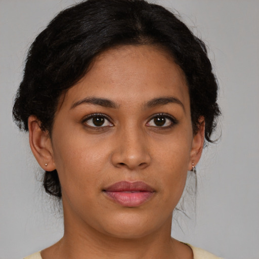 Joyful latino young-adult female with short  brown hair and brown eyes