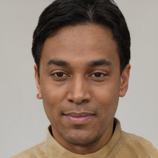 Joyful latino young-adult male with short  black hair and brown eyes