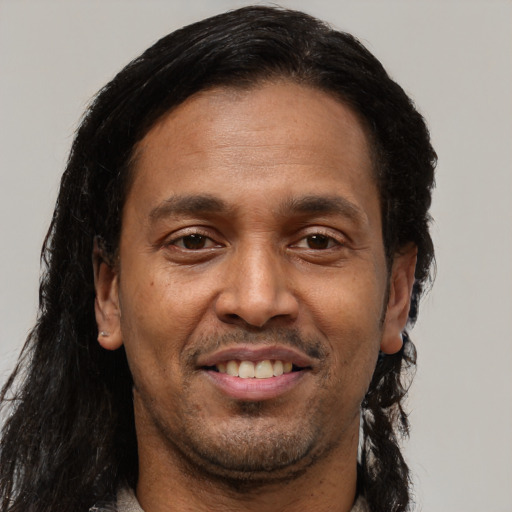 Joyful black adult male with short  brown hair and brown eyes