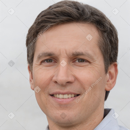 Joyful white adult male with short  brown hair and brown eyes