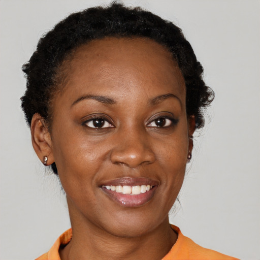 Joyful black young-adult female with short  brown hair and brown eyes