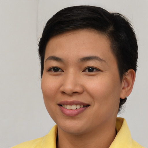 Joyful asian young-adult female with short  brown hair and brown eyes