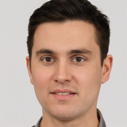 Joyful white young-adult male with short  brown hair and brown eyes