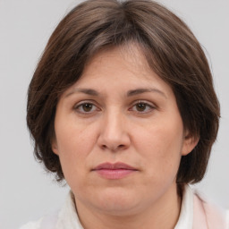 Joyful white adult female with medium  brown hair and grey eyes