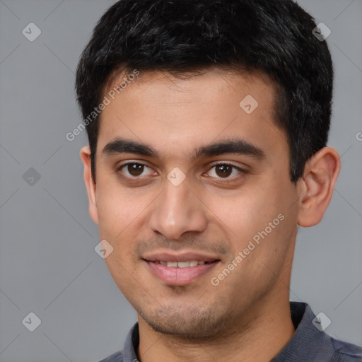 Joyful white young-adult male with short  black hair and brown eyes