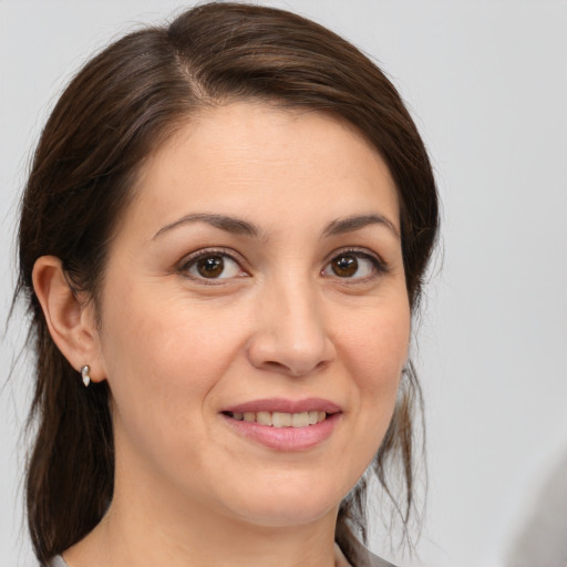 Joyful white young-adult female with medium  brown hair and brown eyes