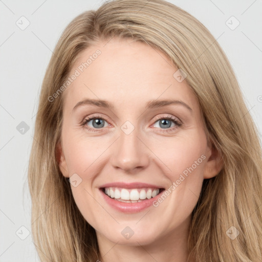 Joyful white young-adult female with long  brown hair and blue eyes