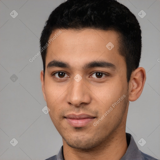 Joyful latino young-adult male with short  black hair and brown eyes