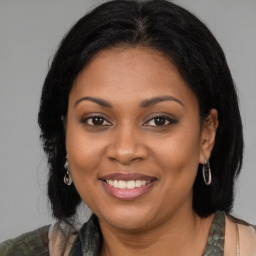 Joyful black young-adult female with medium  brown hair and brown eyes