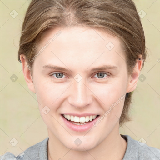 Joyful white young-adult female with medium  brown hair and blue eyes