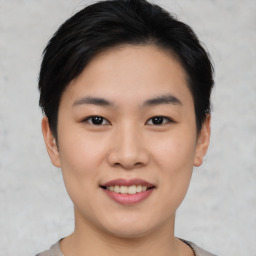 Joyful asian young-adult female with short  black hair and brown eyes