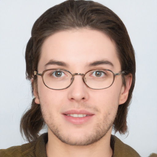 Joyful white young-adult male with medium  brown hair and grey eyes