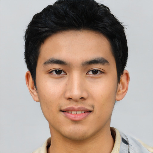 Joyful asian young-adult male with short  black hair and brown eyes
