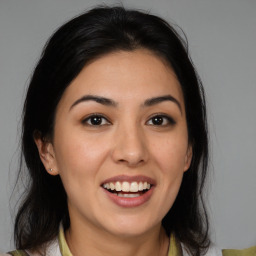 Joyful latino young-adult female with medium  brown hair and brown eyes