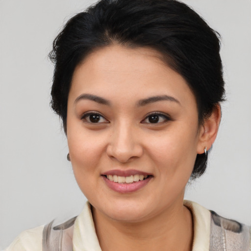 Joyful latino young-adult female with medium  brown hair and brown eyes