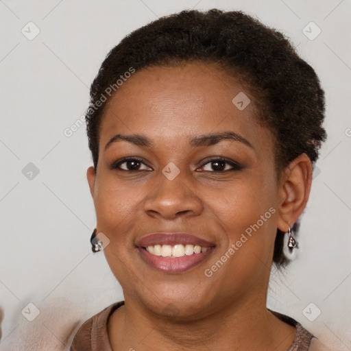 Joyful black young-adult female with short  brown hair and brown eyes