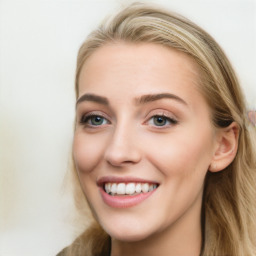 Joyful white young-adult female with long  brown hair and blue eyes