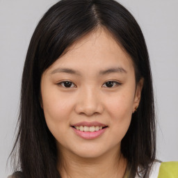 Joyful asian young-adult female with long  brown hair and brown eyes