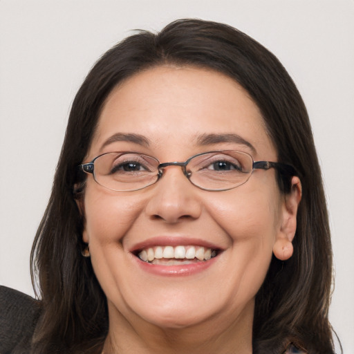 Joyful white adult female with long  brown hair and brown eyes