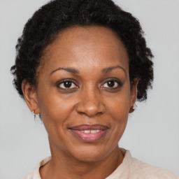 Joyful black adult female with short  brown hair and brown eyes
