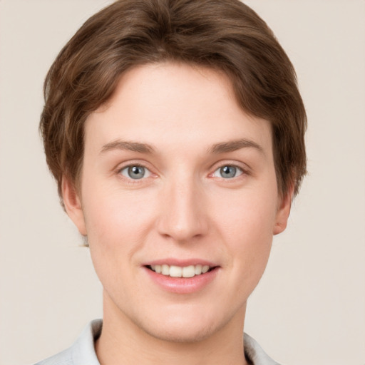 Joyful white young-adult female with short  brown hair and grey eyes