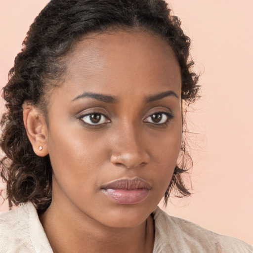 Neutral black young-adult female with medium  brown hair and brown eyes