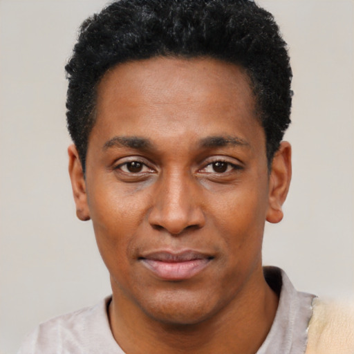 Joyful black young-adult male with short  black hair and brown eyes