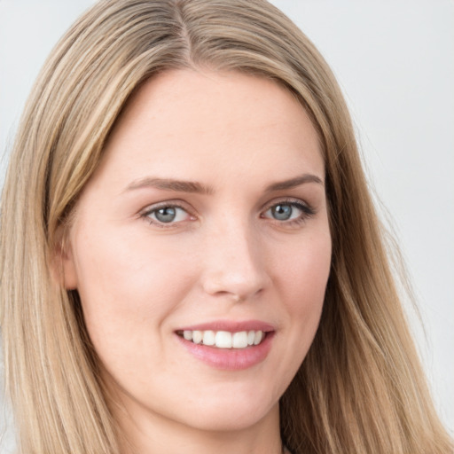 Joyful white young-adult female with long  brown hair and blue eyes