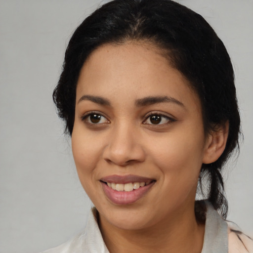 Joyful latino young-adult female with medium  black hair and brown eyes