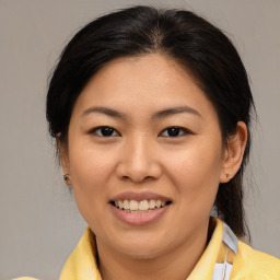 Joyful asian young-adult female with medium  brown hair and brown eyes