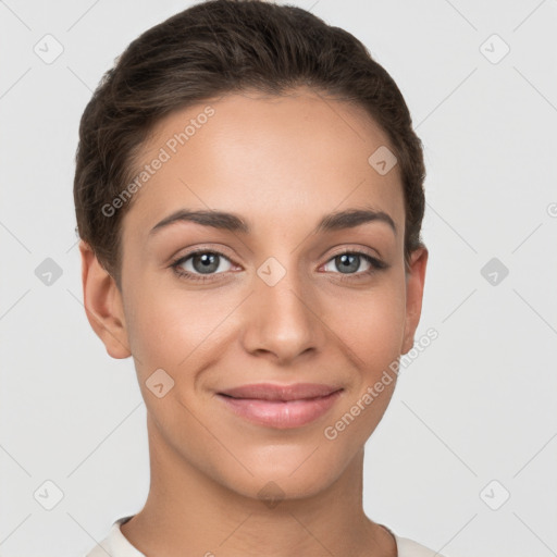 Joyful white young-adult female with short  brown hair and brown eyes