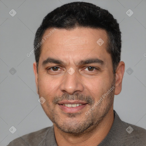 Joyful white adult male with short  black hair and brown eyes