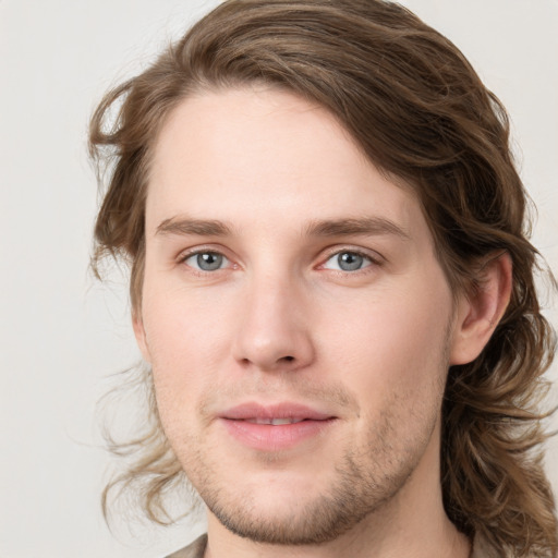 Joyful white young-adult male with medium  brown hair and grey eyes