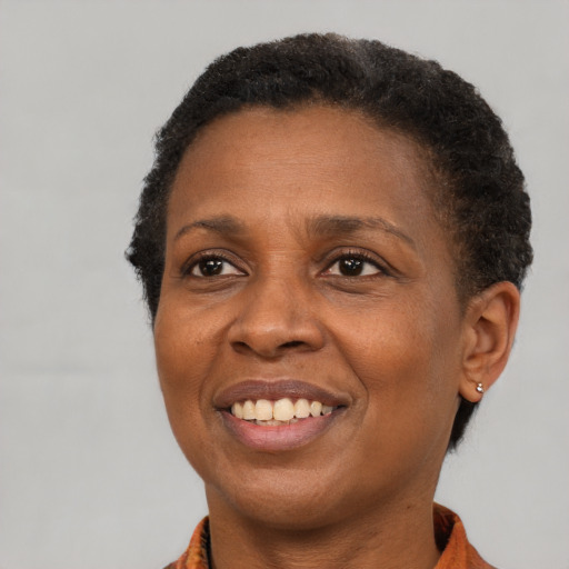 Joyful black adult female with short  brown hair and brown eyes