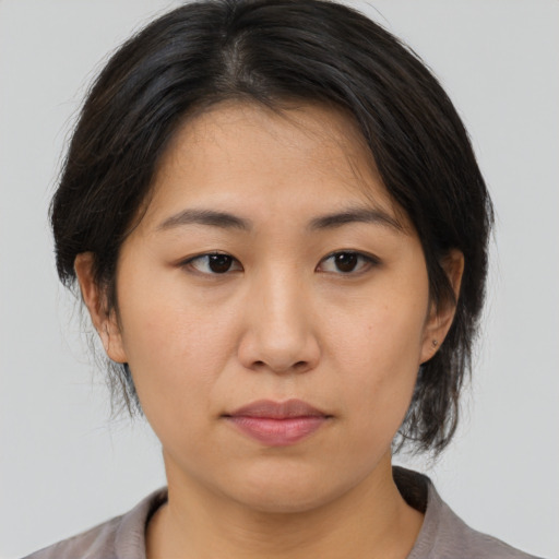 Neutral asian young-adult female with medium  brown hair and brown eyes