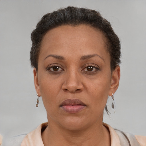 Neutral latino adult female with short  brown hair and brown eyes