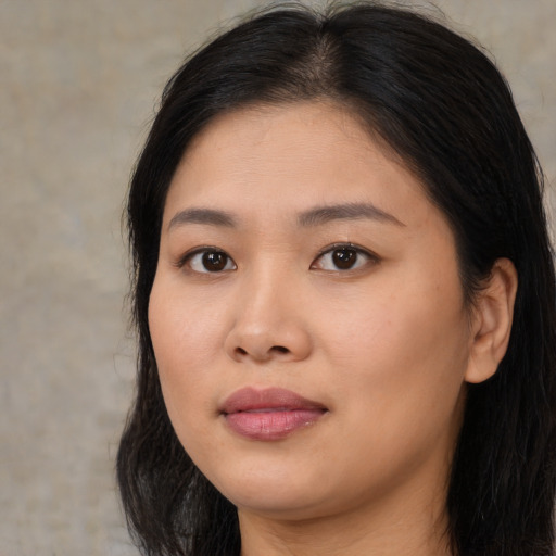 Joyful asian young-adult female with long  brown hair and brown eyes