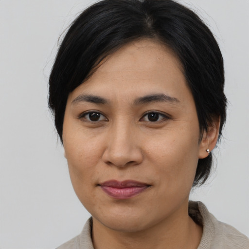 Joyful asian young-adult female with medium  black hair and brown eyes